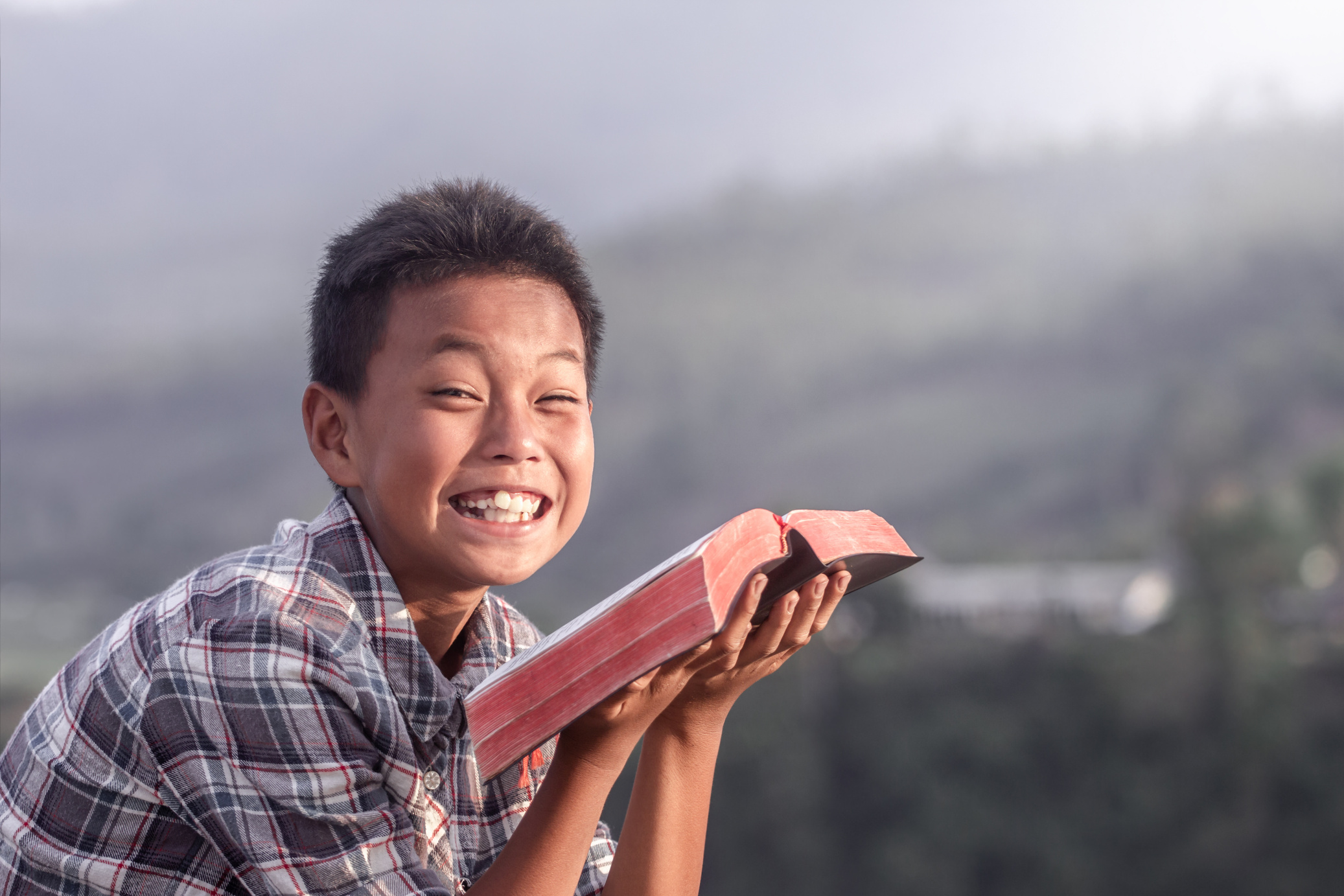 Smiling Child Rading Bible